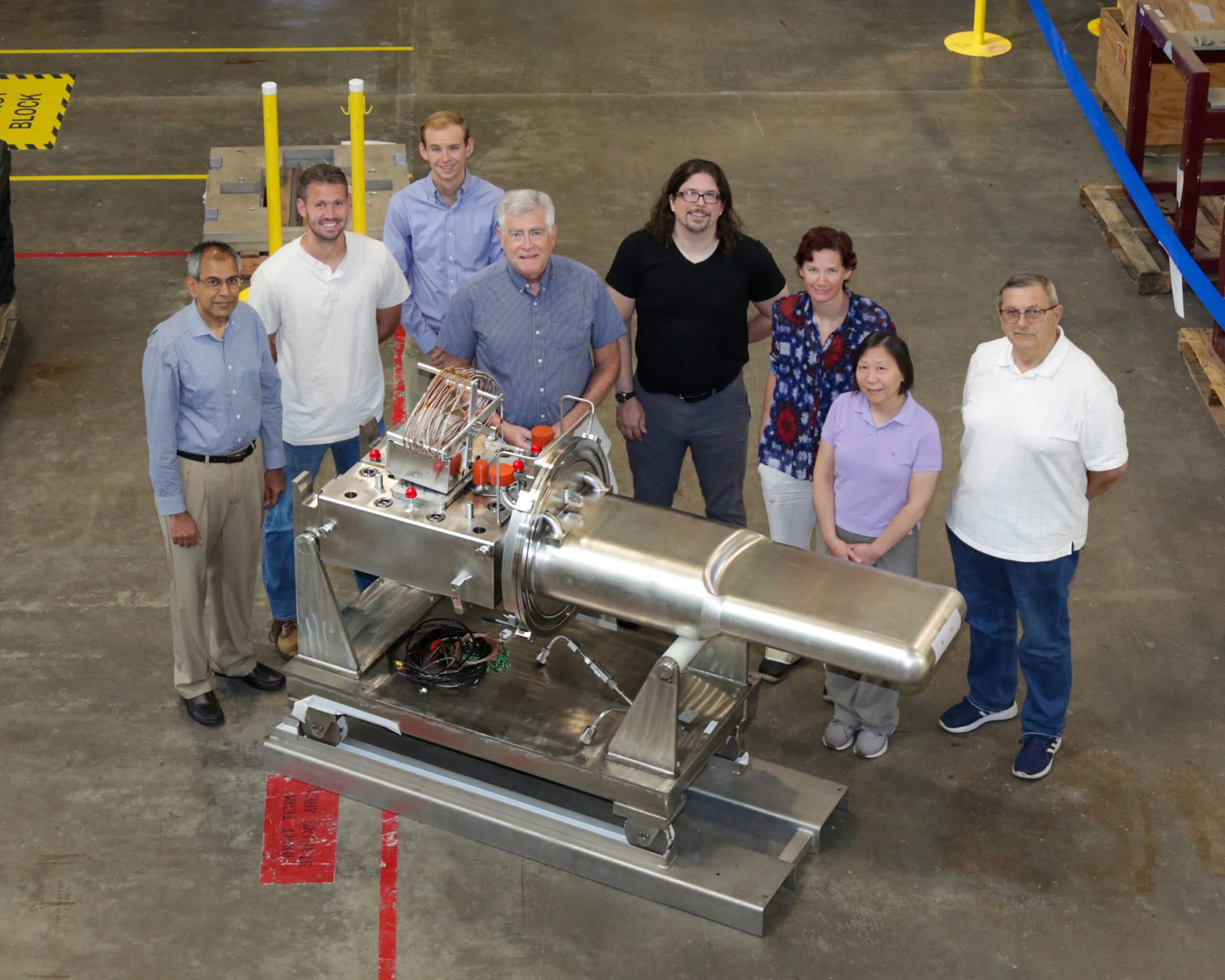 Members of the target design team pose next to the 2.0-megawatt-capable mercury flow target they developed.