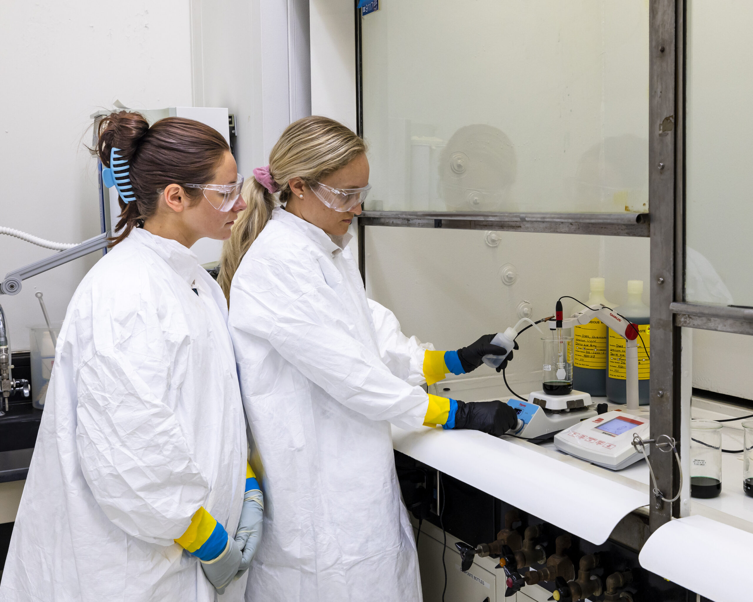 From left, ORNL’s Carson Evans and Kayron Rogers prepare to perform an ISO 17025-accredited Davies and Gray titration, a precise and accurate measurement for assaying uranium. Credit: Carlos Jones/ORNL, U.S. Dept. of Energy