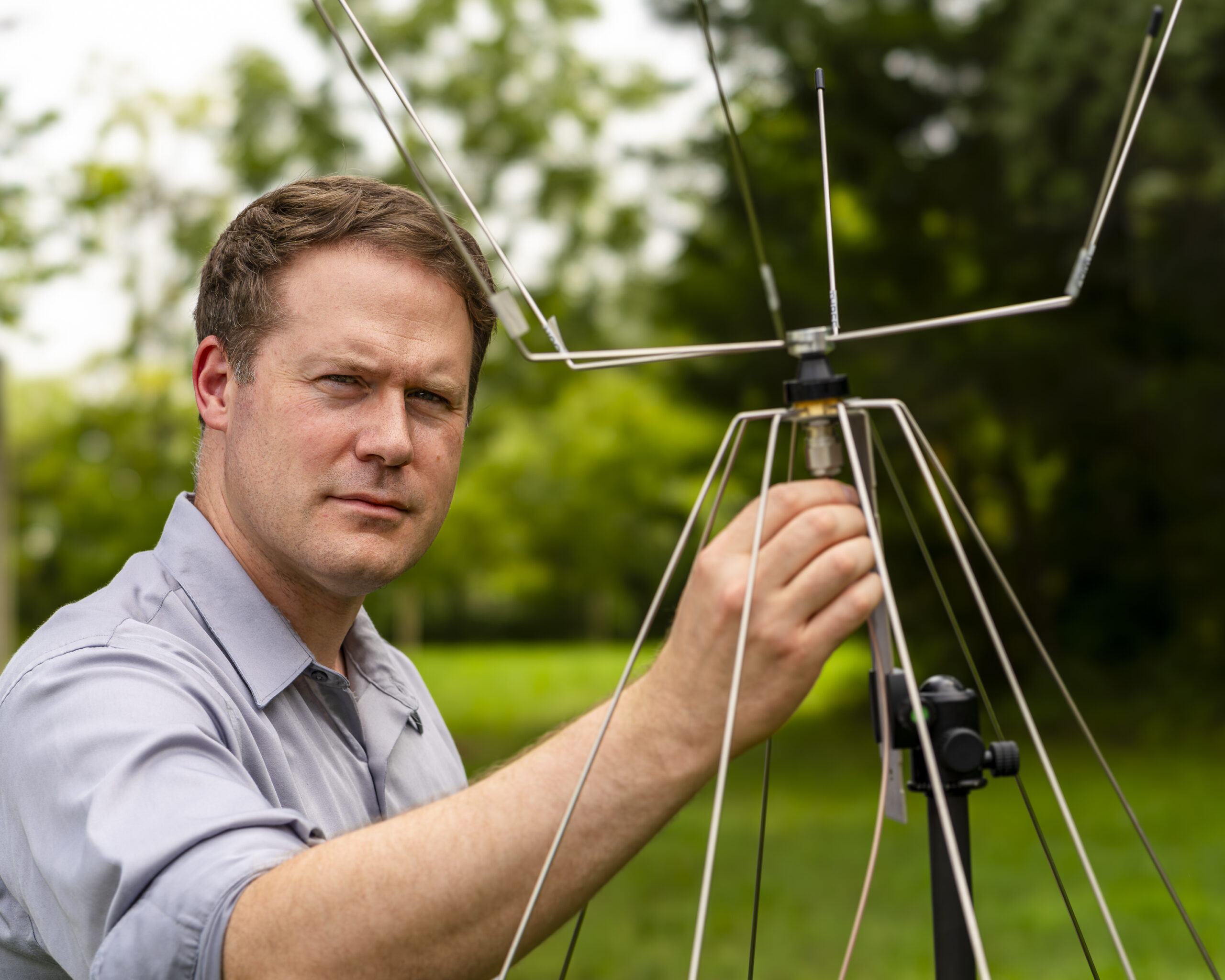 ORNL researcher Corey Cooke is pictured holding an antenna at ORNL
