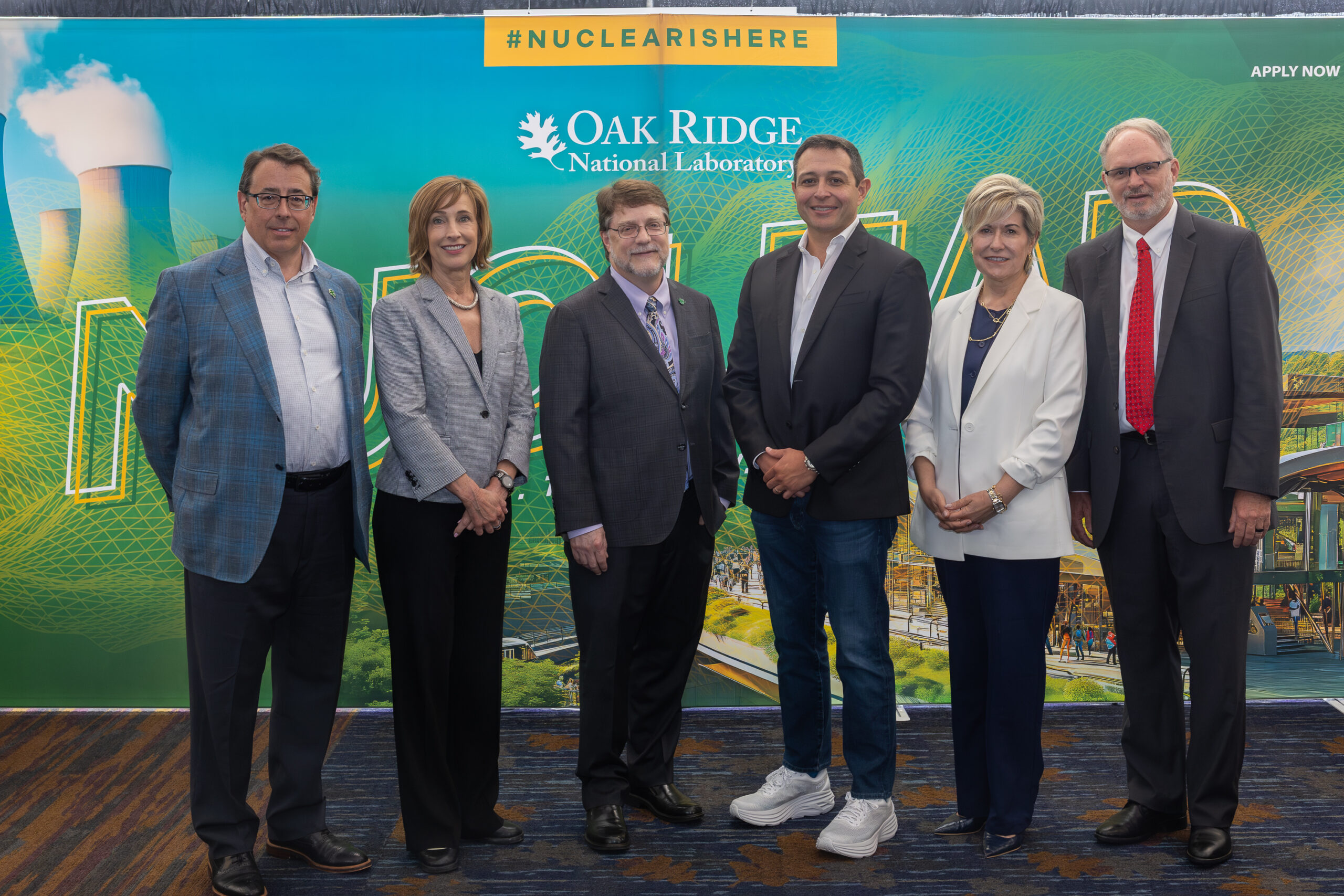 5 members of ORNL's leadership and one CEO is standing for a photo in front of a sign that says "Oak ridge National laboratory"
