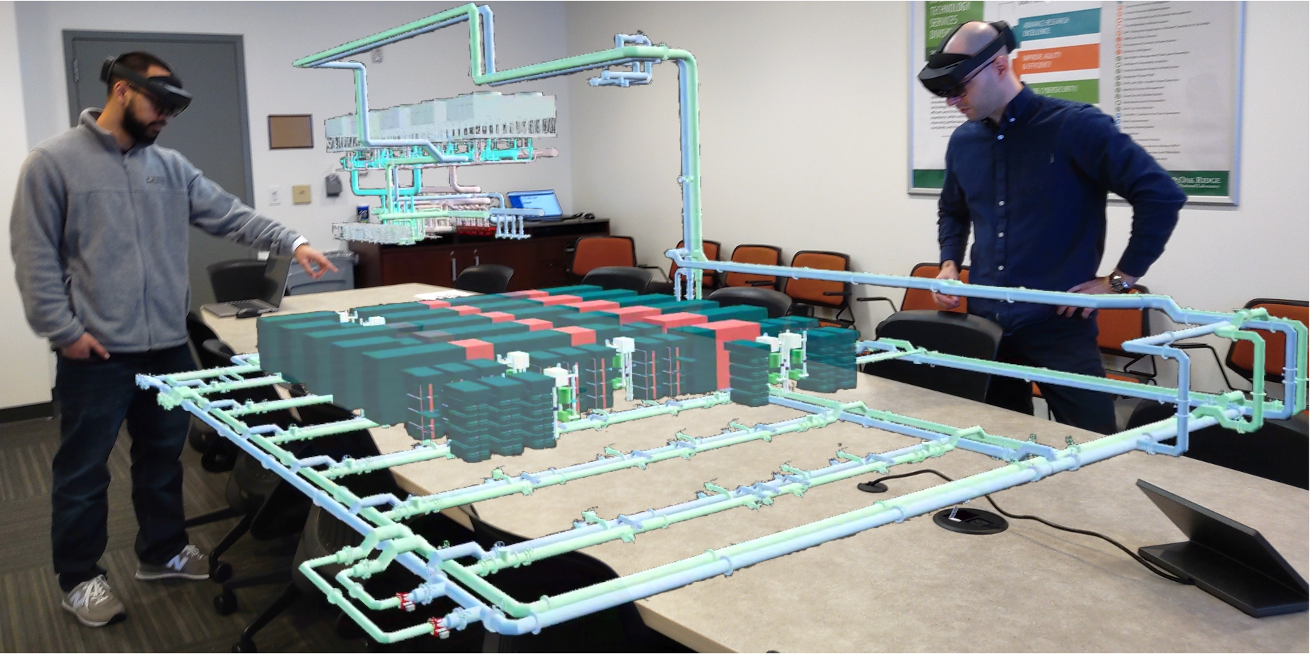 From left, Sedrick Bouknight and Matthias Maiterth of ORNL’s Analytics and AI Methods at Scale group demonstrate the VR capabilities of the Frontier digital twin project's ExaDIGIT framework. Using VR allows Frontier's operators to exam the system's telemetry in a more interactive and intuitive way.