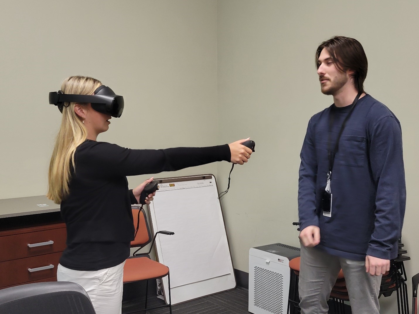 Two researchers demonstrating augmented reality tools.