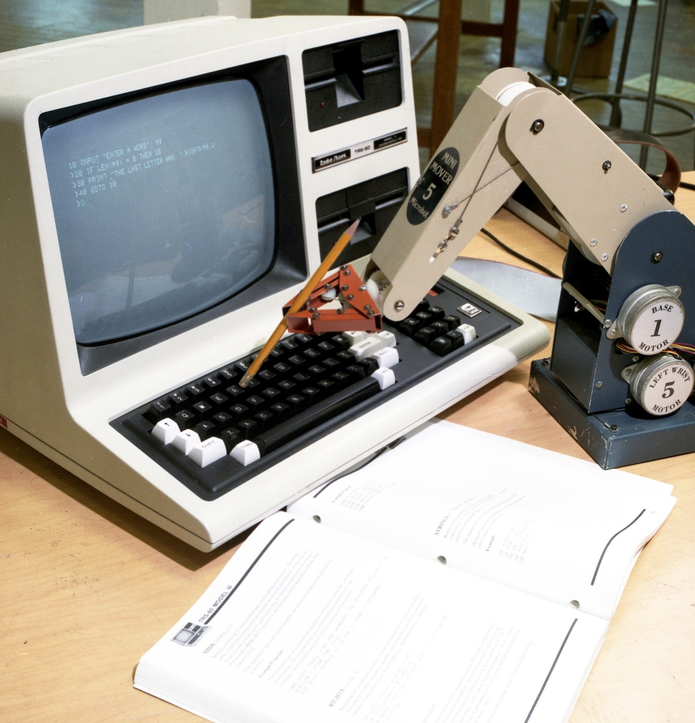A computer is typing on its own keyboard using a programmed robotic arm. Credit: ORNL, U.S. Dept. of Energy.