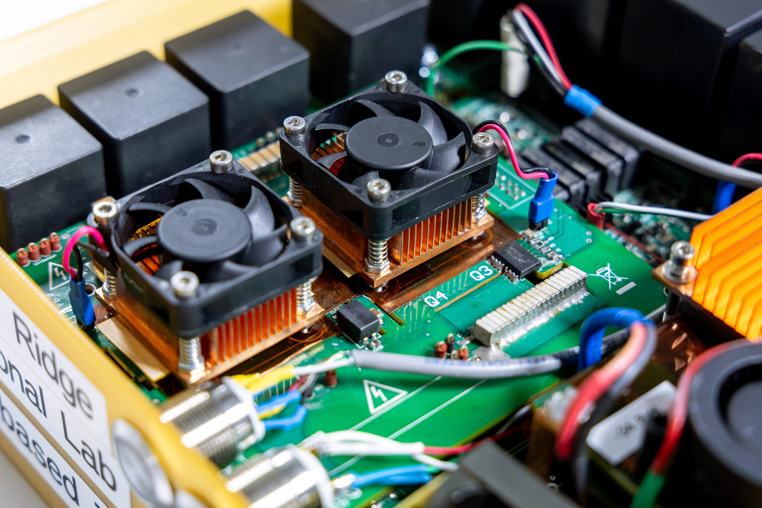 Close-up of a GaN-based 7kW LLC converter with cooling fans and circuit components.