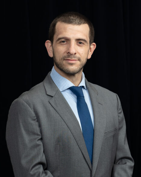 Portrait of Francisco Parada Iturria, international safeguards research professional at Oak Ridge National Laboratory, standing against a studio backdrop.
