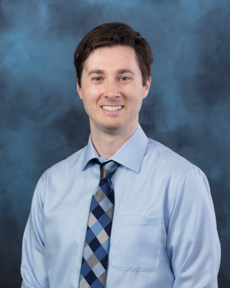 Studio portrait of David Mathews at Oak Ridge National Laboratory. He faces the camera against a neutral studio background.