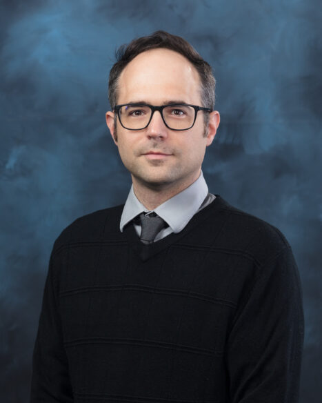 Portrait of Jake Daughhetee, a researcher in radiation detection, imaging, and simulation, facing the camera.