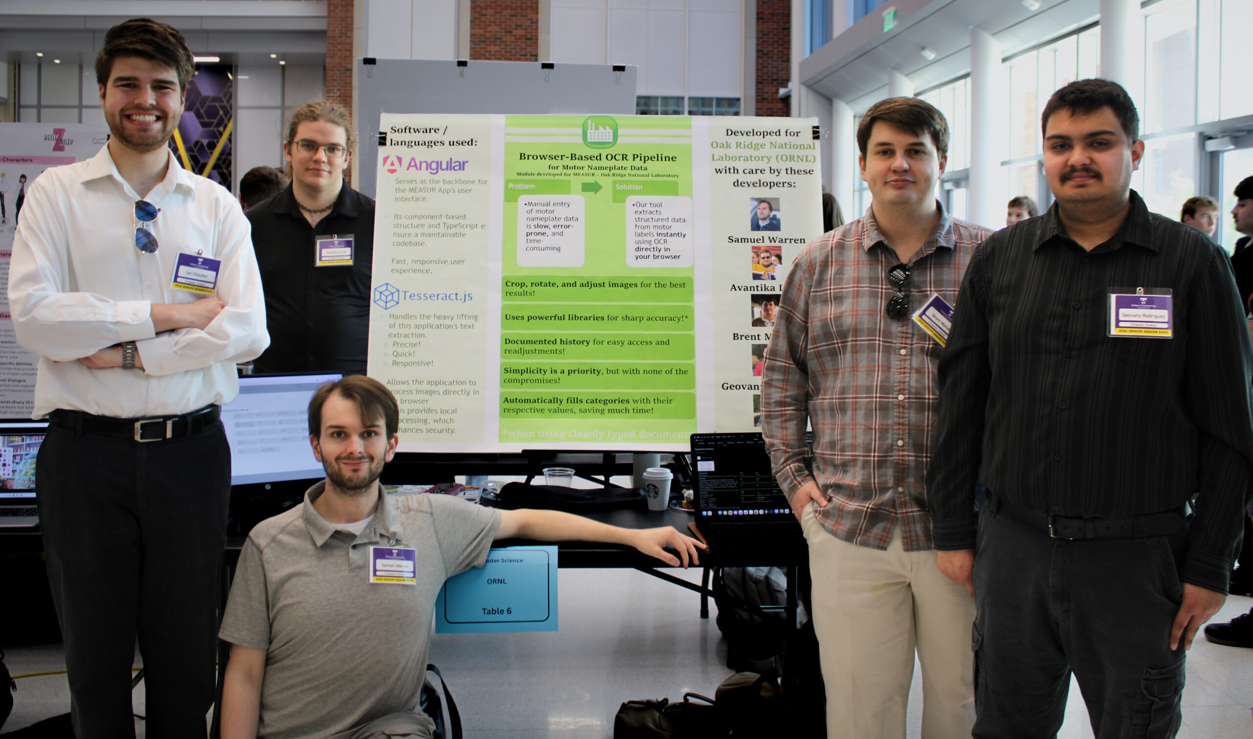 Five students stand and sit beside a research project poster and computer display at a university showcase, presenting a browser-based OCR tool developed for Oak Ridge National Laboratory.