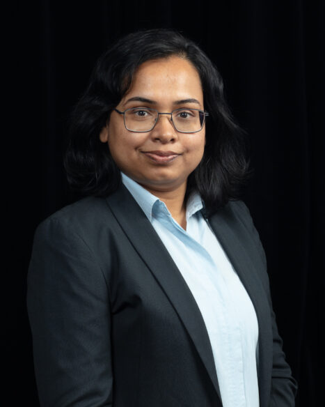 Studio portrait of Moumita Samanta, Data Engineer at Oak Ridge National Laboratory, smiling toward the camera against a neutral studio background.