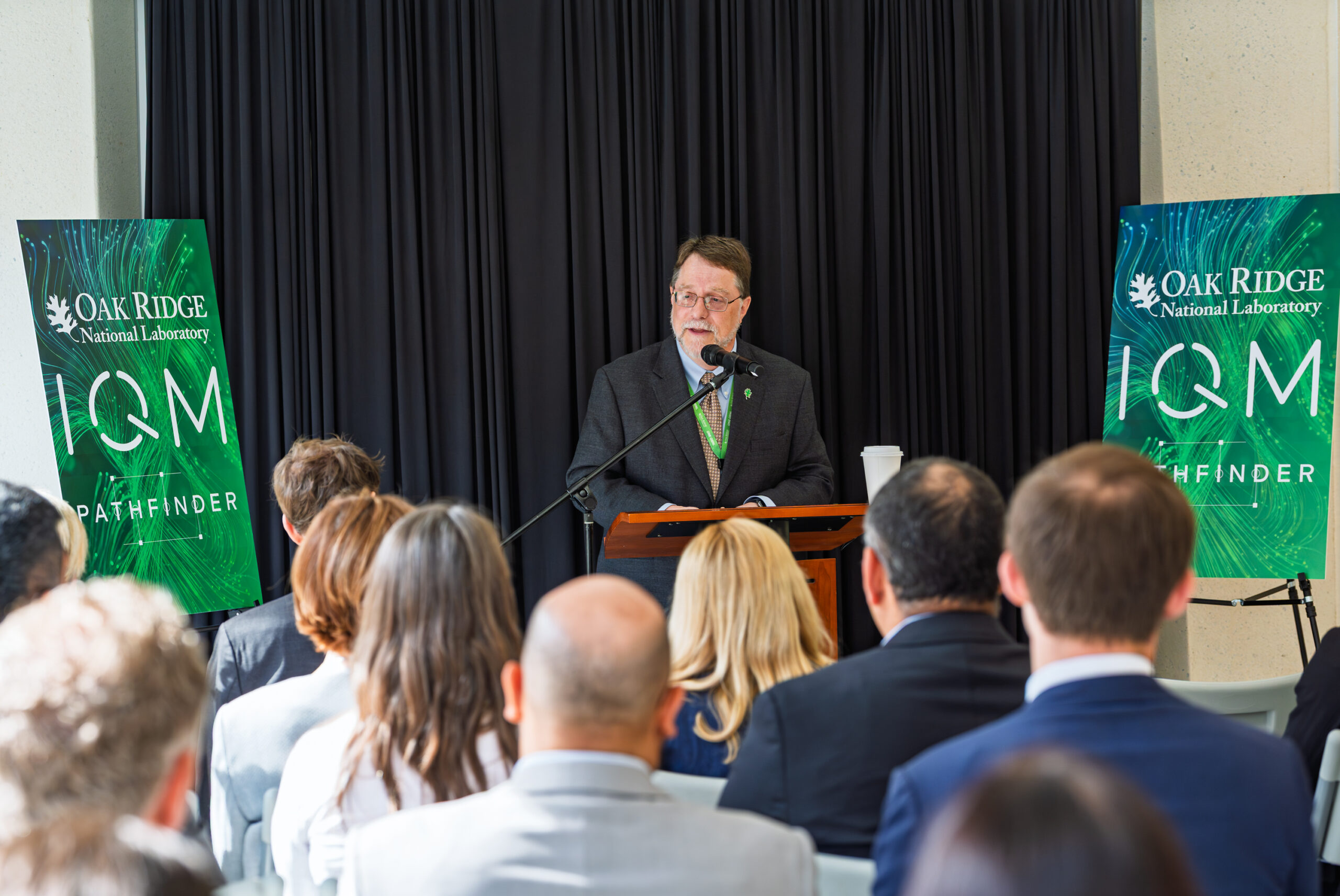 ORNL Director Stephen Streiffer speaks at the launch event for the IQM Pathfinder quantum computer as attendees look on.
