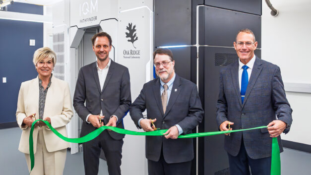 From left, Gina Tourassi, Jan Goetz, Stephen Streiffer and Trey Wheeler cut a ribbon during the opening ceremony for IQM’s quantum computing system at ORNL’s Translational Research Capability facility.