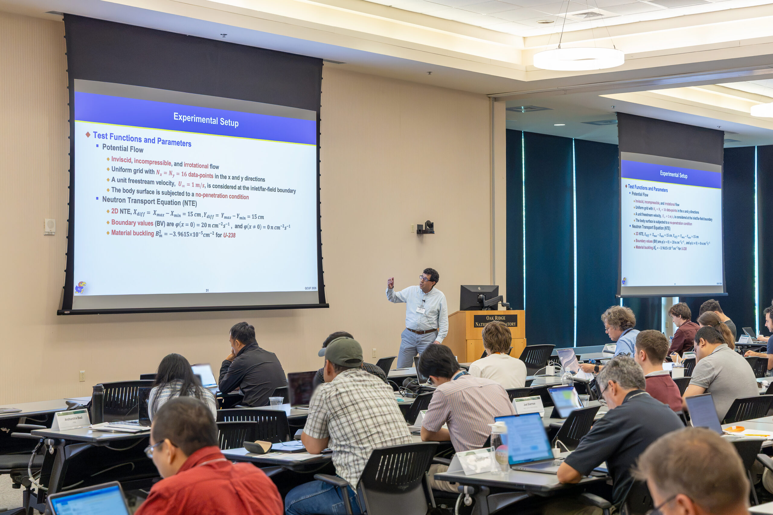 A researcher presents technical results to QCUF attendees.