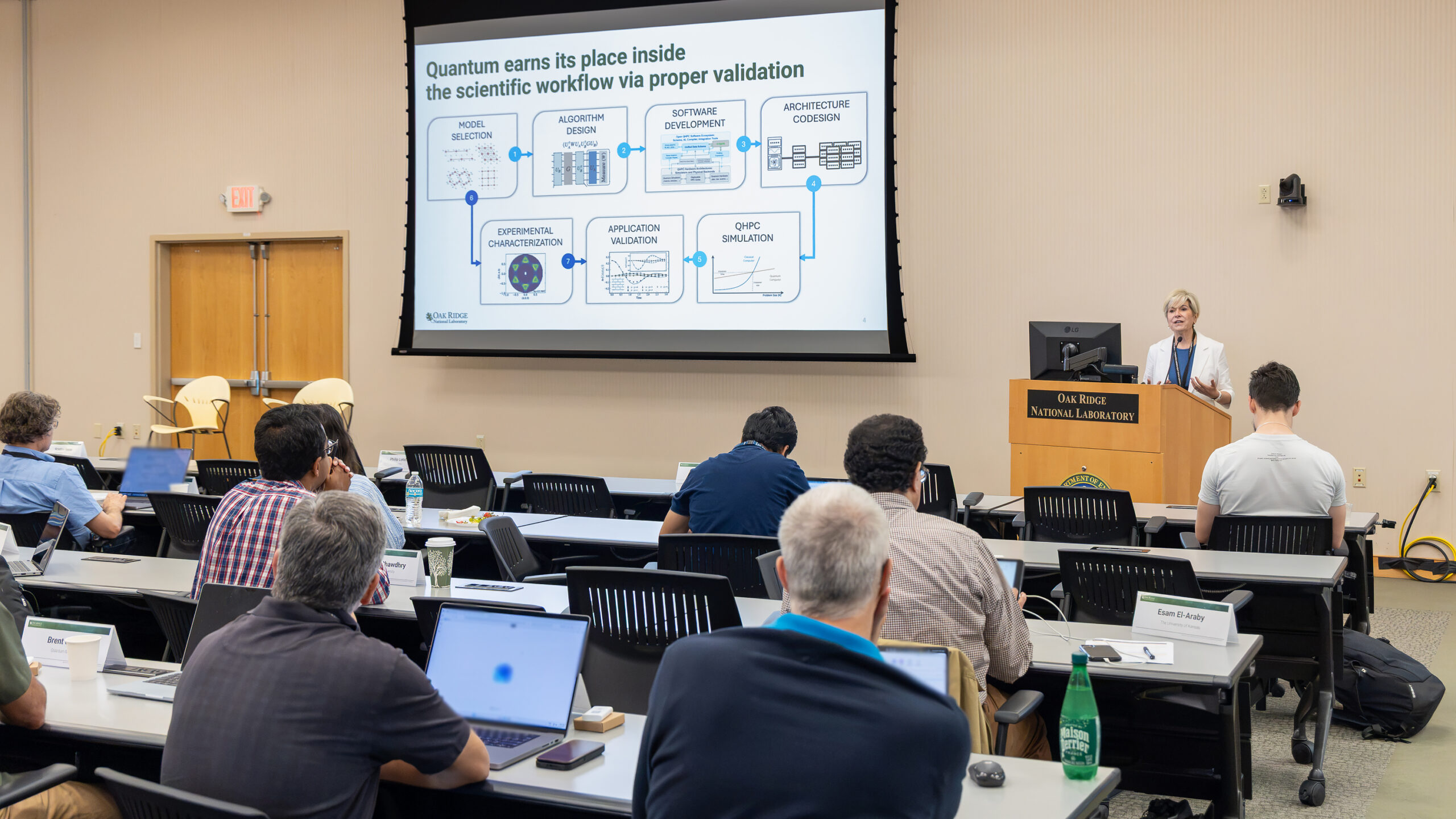 A speaker discusses quantum integration in scientific workflows at QCUF.